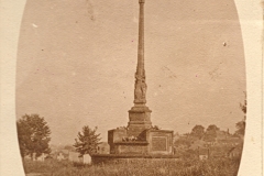 Stone Cross War Memorial, St. Mary's Priory Church, Tutbury, Staffordshire.  Exhibit VP192a from Tutbury Museum.  Photograph on postcard taken looking ESE?  Postcard is dated 26 Sep 1920 hence photo likely to have been taken at the dedication ceremony in May 1920 (wreaths on the memorial).  Note that gravestones are visible in the background - 1860s painting in the museum shows gravestones covering the area implying that this section of the churchyard must have been cleared of headstones to erect the Memorial  However, the painting shows all the headstones leaning significantly, a churchyard in decay and the postcard shows upright gravestones – was painting more 'artistic' than factual?